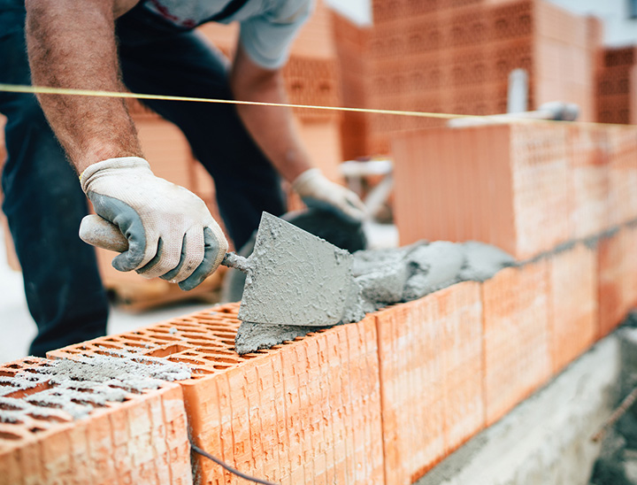 Builder laying bricks on a construction site